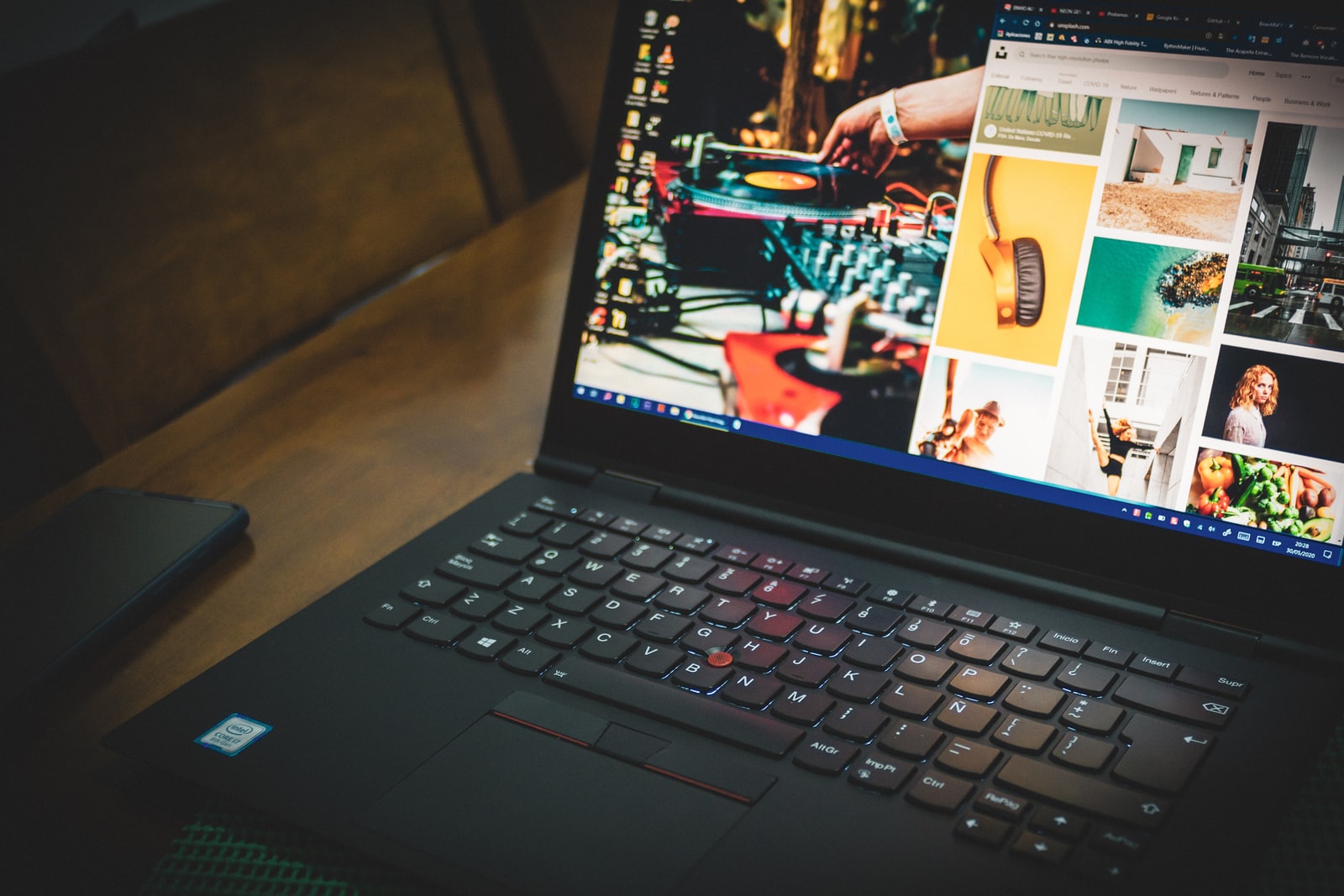 black laptop computer turned on displaying man in black suit